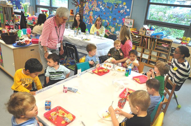 Jo Hicks, 89, watches a group of preschool students while volunteering at Franklin Sherman Elementary School. Hicks has volunteered for years for the school’s preschool program. 

