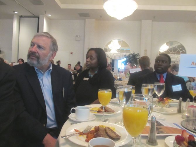 Amanda Andere, (center), FACETS executive director, listens with other guests during FACETS annual benefit breakfast at the Waterford in Fair Oaks Thursday, May 10.