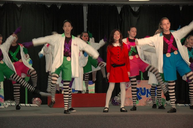 Veruca Salt, center, played by Holly Waters;  Oompa Loompas to her left and right: Taelor Oey and Maia Spoto.