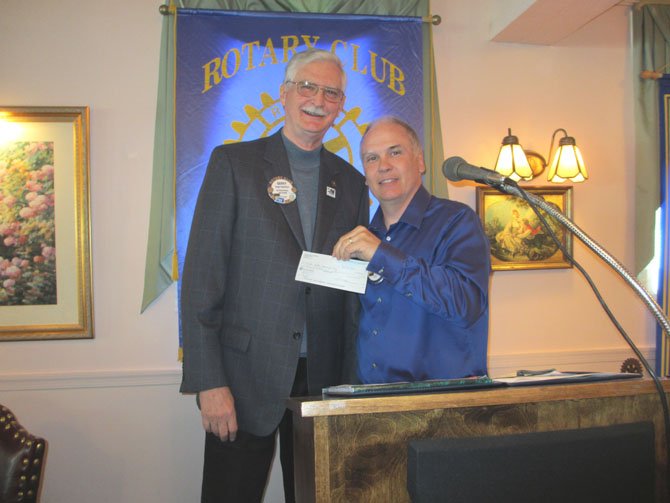Tom Kyllo accepts a check on behalf of the Khristin Kyllo Memorial Fund from the Vienna Rotary Club on May 9.