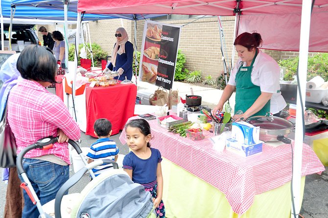 Annie Sidley, chef at the Reston Smart Market, prepares a dish made from ingredients available at the market. 