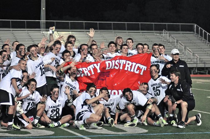 The Saxons celebrate their Liberty District boys' lacrosse finals win over Madison last Friday night. The contest took place at Marshall High School.
