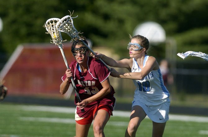 Jackie Rupp (left) scored five goals for the Cougars in their district title game win over top-seeded Centreville last Friday night at Chantilly High School.