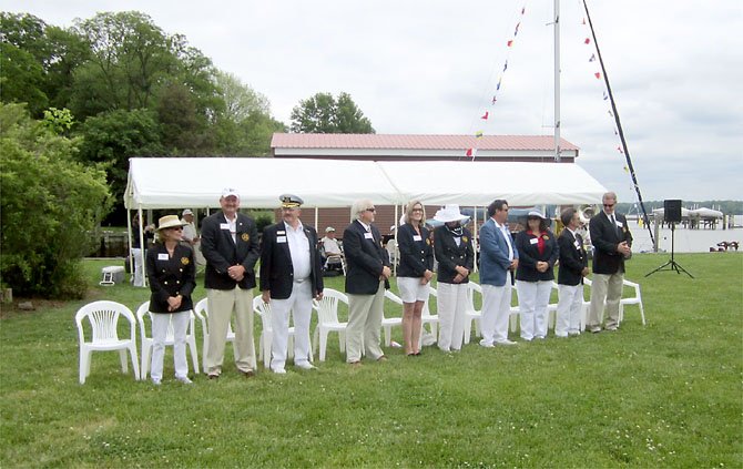 MVYC Officers bow their heads at the annual "Blessing of the Fleet," presented this year by Chaplain Ruth Walsh of St. James Episcopal Church on Old Mill Road. 
