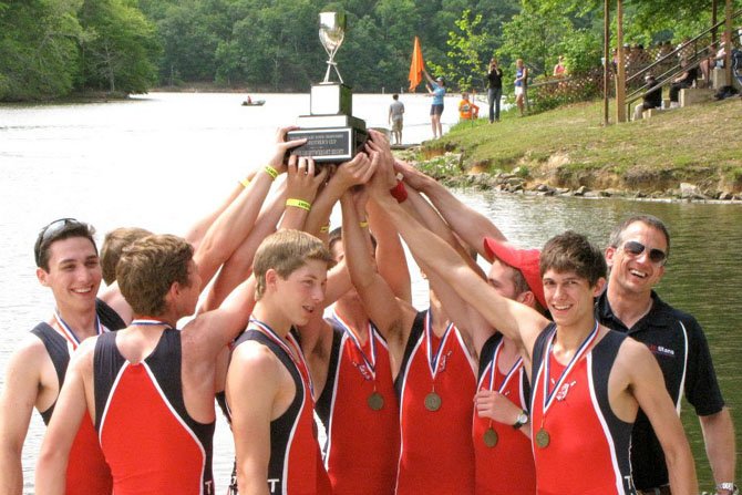 Members of the T.C. Williams boys’ lightweight 8 hoist the Brother’s Cup above their heads following their victory at the Virginia Scholastic Rowing Championship on May 12. Members of the lightweight 8 include: coxswain Brian Comey and rowers Cody Brooks, Ethan Vannatta, David Salmons, Chris Porter, Constantine Ivanis, Sam Zickar, Mitchell Youmans and Ben Blakeslee. The Lightweight 8 is guided by Pete Stramese, the head coach of the T.C. Williams boys’ crew team, who is on the right.