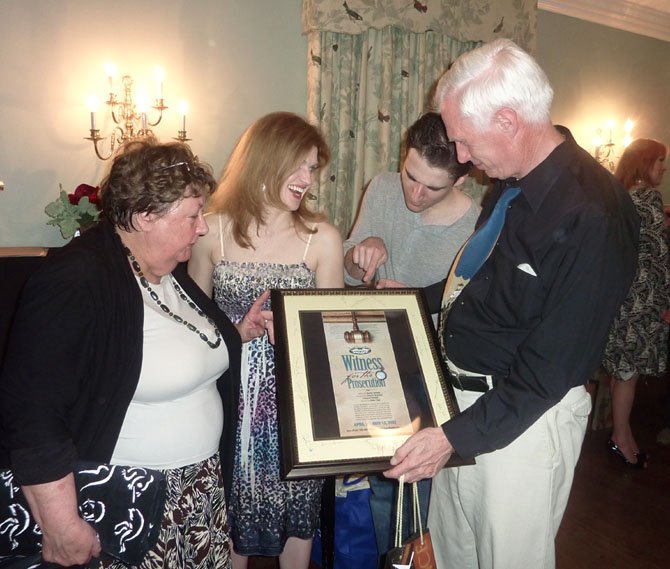 Director Eddie Page, right, is presented with an autographed cast poster by Cheryl Sinsabaugh, Robin Zerbie and Russell Silber at the wrap party for LTA's “Witness for the Prosecution" May 12.
