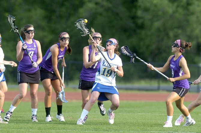 Robinson's Megan Barlow is surrounded by Chantilly High Chargers in recent Concorde District playoff action.