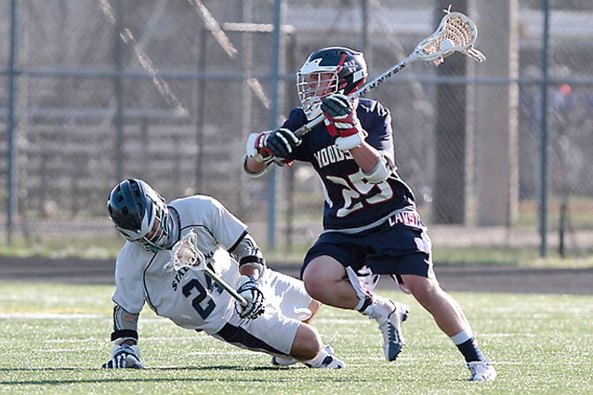 Woodson’s Pat Valentino controls the ball against South County’s Alisher Pazylbekov during the Patriot District boys’ lacrosse tournament final on May 11 at Lee High School.