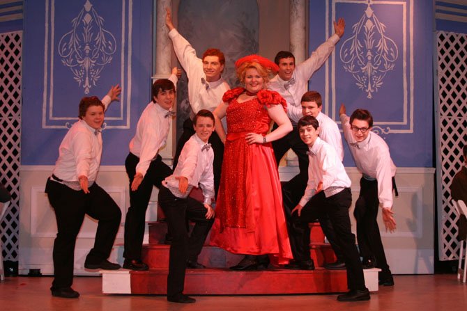 Sean Pugerude, in the title role, is surrounded by the Waiters Ensemble in a number from Paul VI’s musical, "Hello, Dolly!"