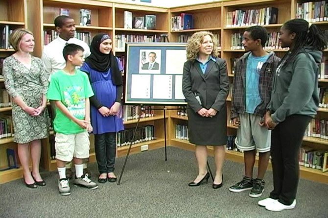Michele Wong, 8th grade from Cameroon; Sana Iqbal, 8th grade from Pakistan; Michael Bedada, 7th grade from Ethiopia; and Phong Pham, 7th grade from Vietnam presented their framed letter and Obama’s response to Marsha Manning, principal of the new South County Middle School.