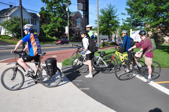 Cyclists wait to cross Elden Street during Bike to Work Day Friday, May 18. 