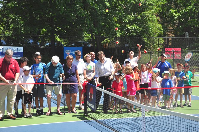 Reston officials, residents and children cut the ribbon on the new under 10 children’s tennis courts Saturday, May 19. Six courts were created out of two previously existing full sized ones. 