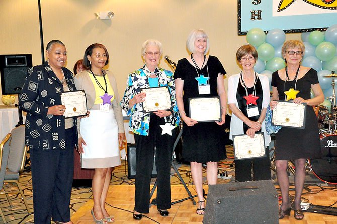 Herndon-Reston FISH named, from left, Mary Allen and Felicia Roney of the National Rural Telecommunications Cooperative, Helen Sellman, Sue Maynard, Chris Griffin and Diane Hardcastle as their Star FISH volunteers of the year Saturday, May 19 at the annual FISH Fling. 