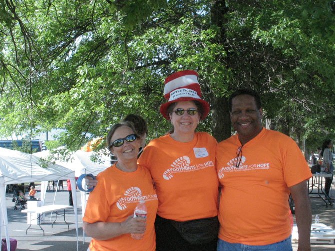 From left, Holly Wieland, a volunteer and Registered Nurse of Herndon; Mary Ann Kral, who supports Connections for Hope on behalf of Vecinos Unidos, and Cornell Harris, a Consultant and Partner at WIPRO, who is on the Advisory Council of Connections for Hope and describes his role at the event as "Parking Coordinator."

