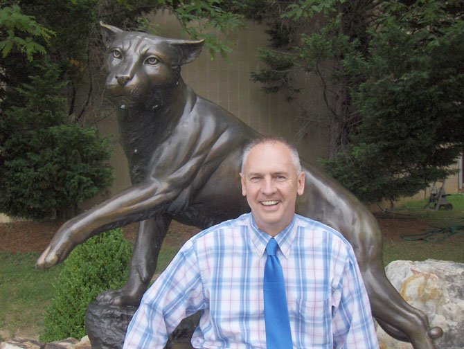 Centreville High Principal Mike Campbell and the statue of the school’s wildcat mascot.