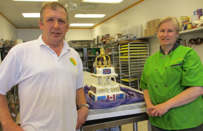 The Pure Pasty Co. owner Mike Burgess and chef Nicola Willis-Jones with the Queen Elizabeth II Diamond Jubilee fruitcake Willis-Jones and fellow Pure Pasty chefs created.