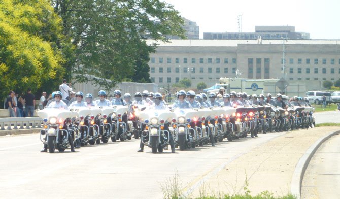 Motorcycle police officers from around the region line up just moments before leading the start of Rolling Thunder 2012.

 

