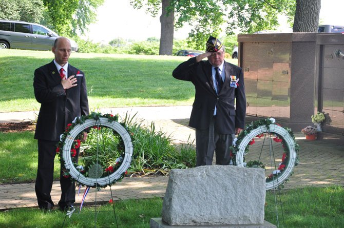 Herndon Mayor Steve DeBenedittis and American Legion Post 184 Commander Dave Kirby salute wreaths laid at the graves of two unknown Confederate soldiers at Chestnut Grove Cemetery Monday, May 28. 