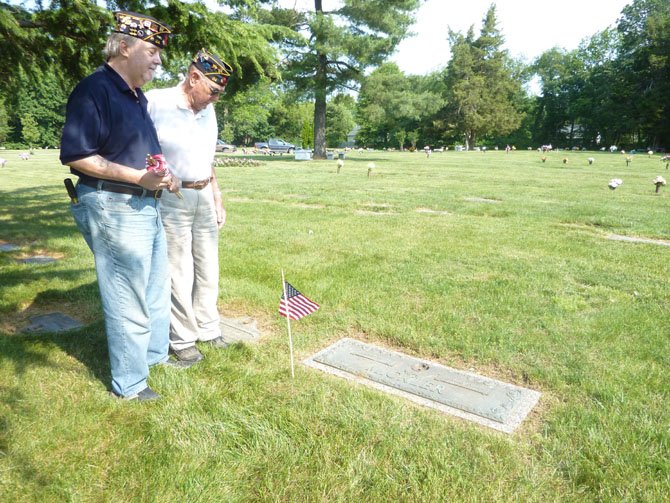 Veterans Jim Glassman and Warden Foley pay their respects at the grave of Thomas Mickler, a fellow veteran and former commander of American Legion Post 24.
