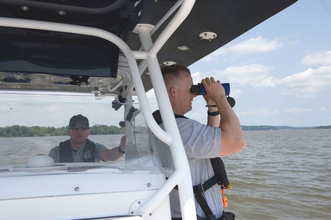 PFC Brian Bowman (left) and PFC Matthew Grubb start their shift with the Fairfax County Police Marine Patrol Unit on May 26 looking for safety violations, unsafe boaters, or anything that looks out of the ordinary. They are patrolling Fairfax County shoreline and waterways. Grubb is a full time officer with the Marine Patrol Unit and Bowman is an officer at the Fair Oaks Station, qualified to assist the unit. From Memorial Day weekend to Labor Day, the Unit is on patrol seven days a week enforcing water safety rules and regulations and educating the public about water safety.