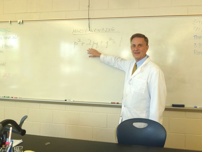 Biology teacher David Keener prepares notes on evolution for his fourth period class.