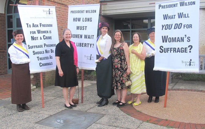 Standing Up for Women’s Rights – Anne Stuntz, president of Historic Vienna, Inc.; Leigh Kitcher, treasurer of Historic Vienna, Inc.; and Paula Elsey stand with the Silent Sentinels reenacting a picket at the 2012 Turning Point Suffragist Memorial award ceremony held at Meadowlark Botanical Gardens in Vienna on Wednesday, May 30.