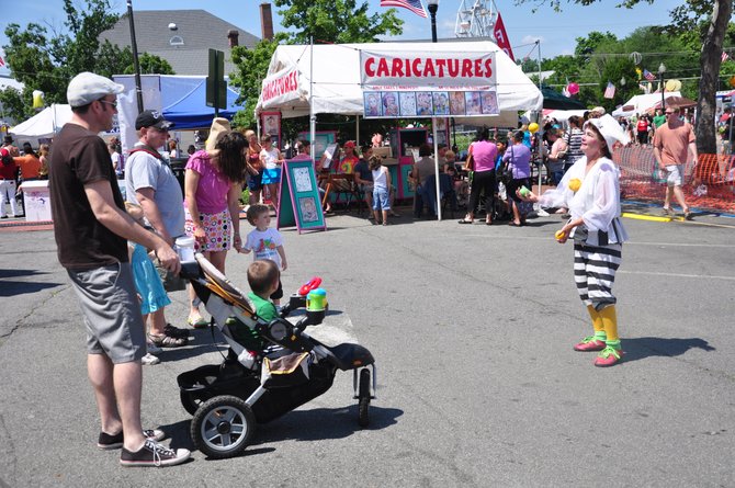 Guests at the Herndon Festival watch a juggler perform at the Kid’s Alley Sunday, June 3. 