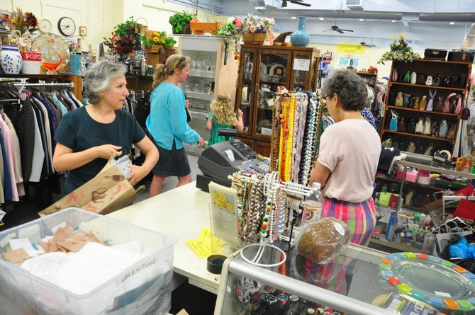 Volunteers at The Closet in Herndon will open the nonprofit thrift store the last Thursday evening of each month to try to attract more shoppers. 