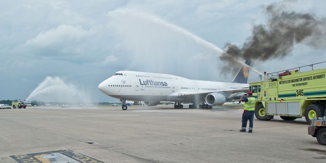 The new Boeing 747-8, operated by Lufthansa is met as it lands at Dulles Airport after its first ever commercial flight with a water cannon salute. 