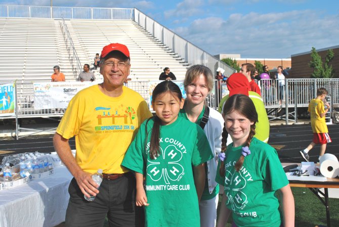 Race Director, Mark Russell of Springfield, left, with three of his 150 volunteers
"This event (5k/15k Races at Springfield Days) gets better and better every year. This year we have live music, good food, a moon bounce, and of course everybody loves a track finish." 
