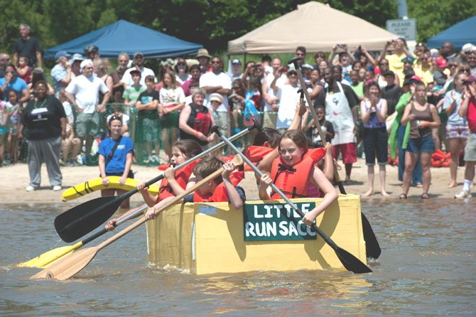 Hundreds of spectators cheer on the participants in the 23rd Cardboard Boat Regatta at Lake Accotink Park on June 3, 2013. This group, from Little Run Elementary School in Fairfax, is working hard to make their way over the finish line before the other competitors in their heat.
