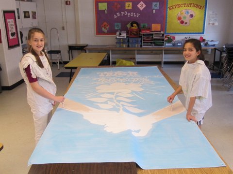 Churchill Road sixth graders Emma Higbee and Maggie Bujor work on the initial design for the school’s environmental studies banner. (Not pictured Linsey Wenk).

