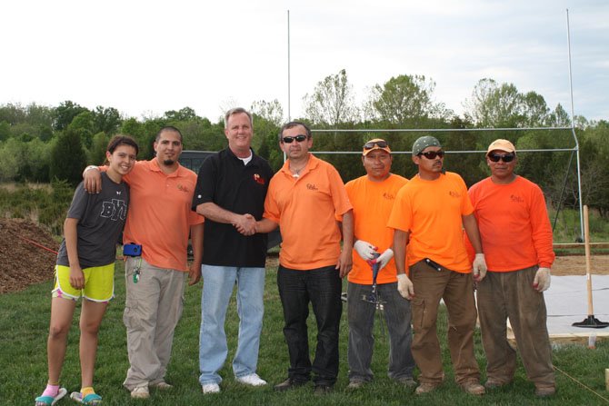 From left are former SYA player Sara Berrios, RulyScapes Operations Manager Marco Lavayen, SYA President Gary Flather and RulyScapes General Manager Raul Berrios with RulyScapes field-crew members