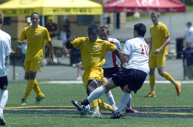 Lake Braddock's Aaron Hollins, with two Albemarle players around him, maneuvers the ball during the Bruins' state semifinals contest at Westfield High School.