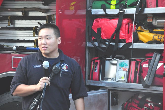 Firefigher Nathan Cheon discusses various features of a fire truck with visitors to the Herndon Neighborhood Resource Center Thursday, June 7. 