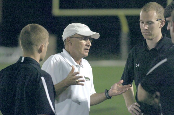 Saxon boys' head coach Earl Brewer (center) and his staff take time to confer during Saturday's state finals game.