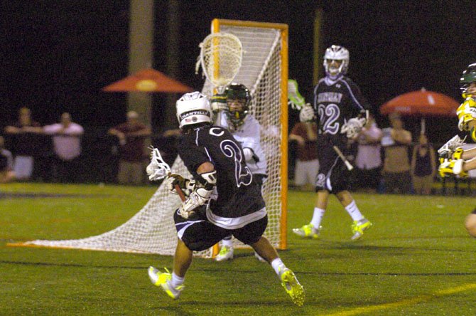 Langley goalie Andrew Spivey tries to anticipate the next move by Chantilly senior midfielder Cole Fitzgerald (2) during Saturday night's state finals lacrosse game at Westfield.