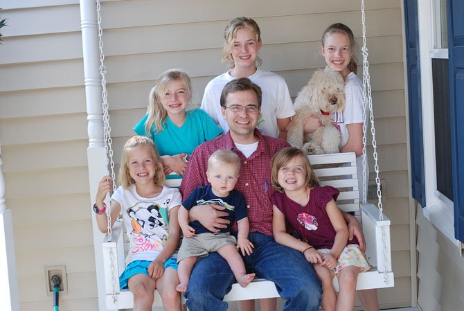 Kevin O'Malley sits with his children on his front porch in Centreville on his birthday (May 2012).  Standing in the back are Kathleen (10), Bridget (12) and Meghan (14) holding Buckley. Sitting on the swing with Kevin is Mary (8), Peter (8 months) and Shannon (4).