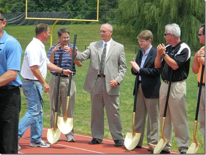 Coach Chris Haddock hands a shovel to outgoing CVHS Principal Mike Campbell, who will be retiring from FCPS this month.