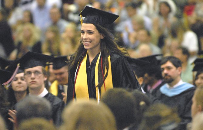 Bethany Hartt, recipient of the Faculty Award, approaches the stage to accept her award that is given to one outstanding senior each year as voted on by the faculty.