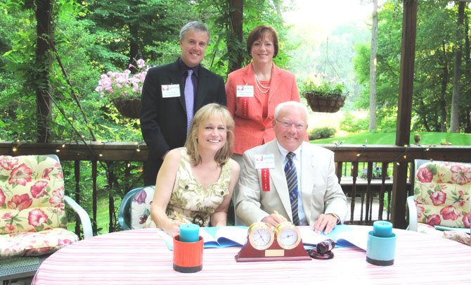 In the "Rose Garden" signing photo, in the front row is Maestra Miriam Burns and President Wayne Winston Sharp, Ph.D. The back row is Executive Director John Huling and President-Elect Aileen Pisciotta, Esq.

