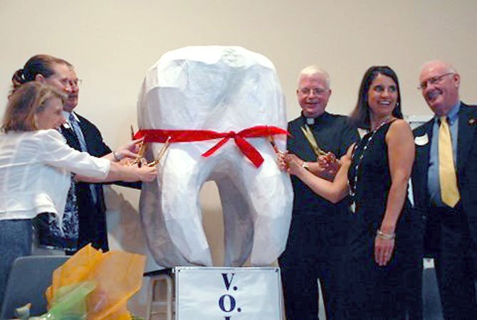 VOICE members cut a ceremonial red tape Sunday at St. John Neumann Catholic Church to celebrate the hiring of a full-time dentist for the western Fairfax County branch of the Northern Virginia Dental Clinic, located in Sterling. VOICE solicited local dental and health care institutions for funds plus received a $100,000 anonymous donation to meet their goal of $200,000 to fund a full-time dentist for two years.

