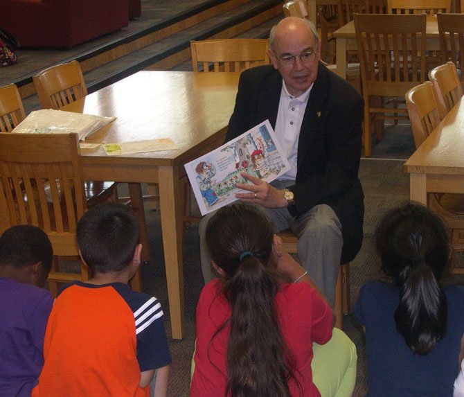 John Woods, president of the Alexandria Rotary Club, helps launch the Books in Alexandria Kids’ Homes book program by reading to kindergarten students at Cora Kelly School for Math, Science and Technology. The program aims to provide books for the personal libraries of young students, to encourage reading at home.