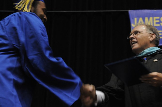 Principal Daniel F. Meier presents the diplomas to Robinson’s Class of 2012 on June 14.