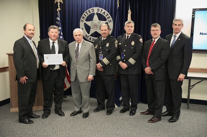 U.S. Marshal for the Eastern District of Virginia Bobby Mathieson, Executive Director of the Northern Virginia Regional Gang Task Force Ray Colgan, Congressman Frank Wolf, Falls Church City Police Chief Harry Reitze, Leesburg Police Chief Joseph Price, FBI Special Agent in Charge Ronald Hosko, and U.S. Attorney for the Eastern District of Virginia Neil MacBride attended the ceremony June 22, in which a check for $850,000 was presented to the Northern Virginia Regional Gang Task Force from the Department of Justice Assets Forfeiture Fund.