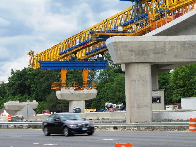 Crews continue to use a huge bright yellow horizontal crane to build the bridges for rail from Route 7 to the median of the Dulles International Airport Access Highway/Dulles Toll Road. This work is expected to be completed in July. 