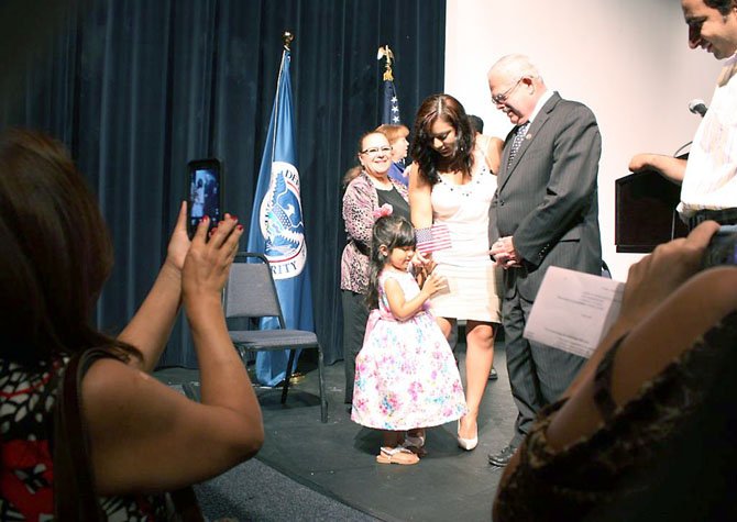 Connolly meets with new citizens after the naturalization ceremony on June 22.