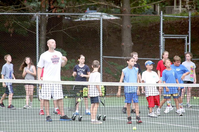 Coach Rob leads a game of "King of The Court" during a junior tennis clinic at Fairfax Station Swim and Tennis Club.