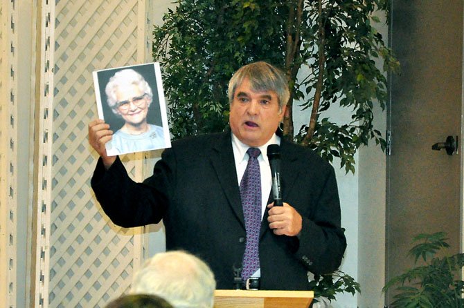 Bill Pelke, co-founder and president of Journey to Hope, an anti-capital punishment organization, holds a picture of his grandmother, who was murdered in 1985. Pelke and other speakers that have been affected by the death penalty spoke at St. John Neumann Catholic Church Monday, June 25. 