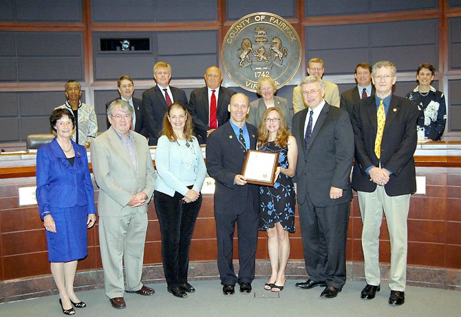 From left, front row: Fairfax Board Chair Sharon Bulova, Herndon Councilmember-elect Dave Kirby, Herndon Councilmember Connie Hutchinson, Mayor DeBenedittis, Rosemary DeBenedittis, Dranesville District Supervisor John Foust, Herndon Councilmember-elect Charlie Waddell. (Back row): Fairfax County Board of Supervisors.